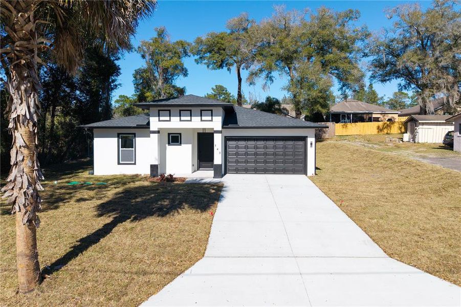 Front exterior of a new home in , Deland, FL, highlighting curb appeal (Image 26).