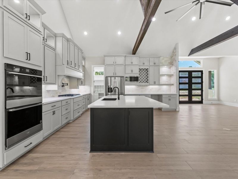 Another view of the kitchen with stainless steel appliances including a double oven, built in dishwasher and fridge. Another view of the kitchen with stainless steel appliances including a double oven, built in dishwasher and fridge.
