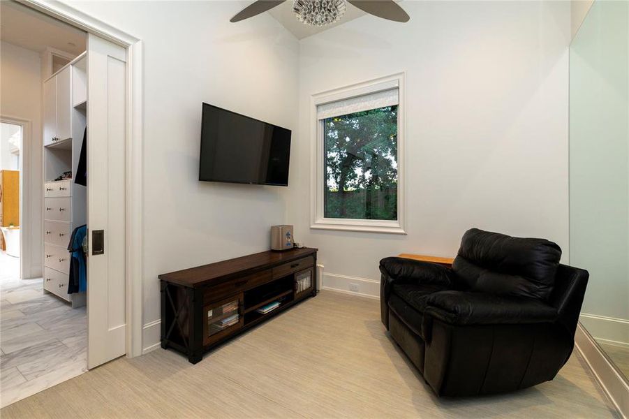 Living area with ceiling fan and baseboards Living area with ceiling fan and baseboards