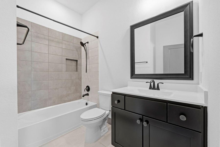 Well-appointed secondary bath with tiled tub/shower combination, modern fixtures, and sleek vanity—offering both style and functionality.