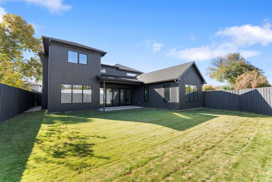 Back of property with a fenced backyard and a patio area Back of property with a fenced backyard and a patio area