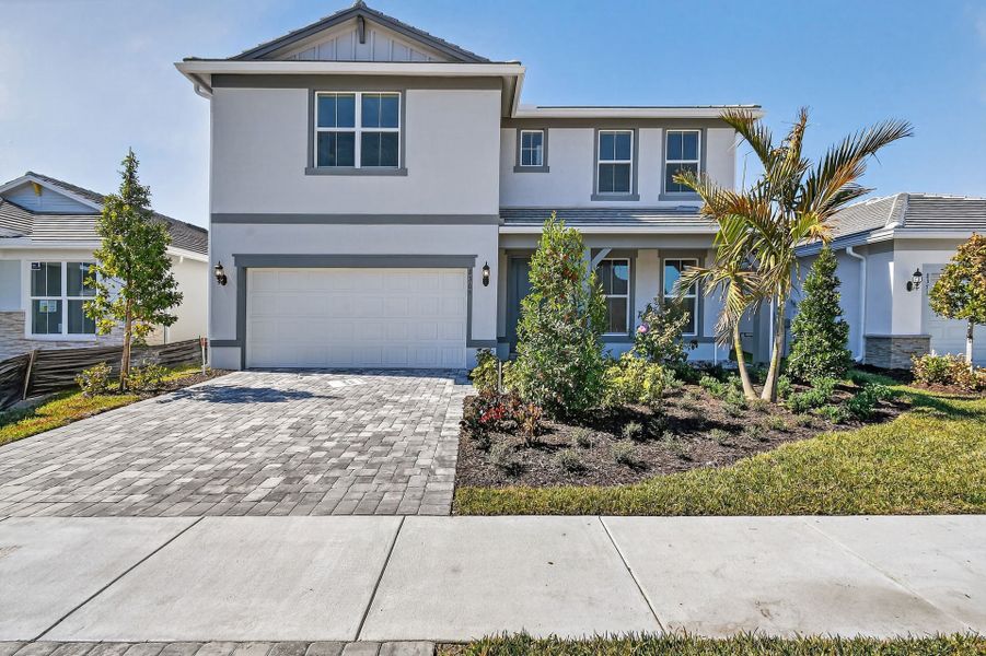 Front exterior of a new home in Harbor Isle, Vero Beach, FL, highlighting curb appeal (Image 30). Front exterior of a new home in Harbor Isle, Vero Beach, FL, highlighting curb appeal (Image 30).
