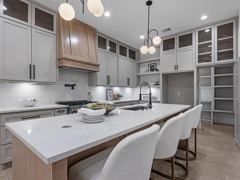 Notice that the cabinets go all the way to the ceiling, along with the black hardware complimenting the overall style.