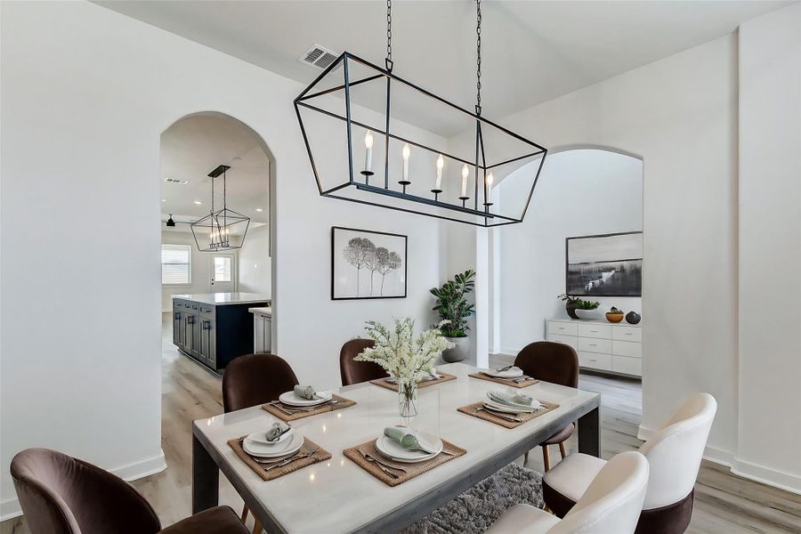 Modern elegance meets functionality! This open-concept layout seamlessly connects the dining area to the kitchen, creating an ideal space for entertaining guests and daily living. **This is a picture of a Rylan Floor Plan from another Saratoga Homes.** Modern elegance meets functionality! This open-concept layout seamlessly connects the dining area to the kitchen, creating an ideal space for entertaining guests and daily living. **This is a picture of a Rylan Floor Plan from another Saratoga Homes.**