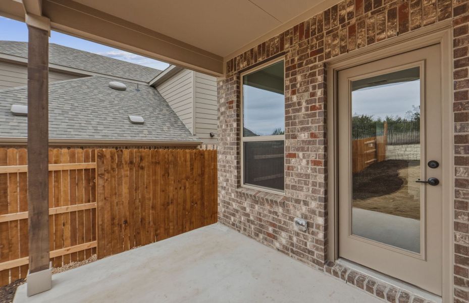 Exterior details and patio area of a home in West Cypress Hills, Spicewood (Image 30).