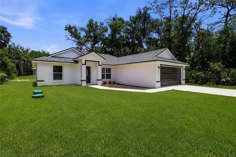 Front exterior of a new home in , Ocklawaha, FL, highlighting curb appeal (Image 2).