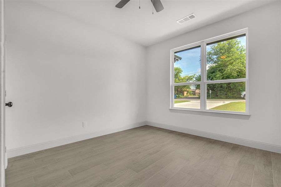 Empty room featuring a ceiling fan and light wood-style flooring, could be an office or another extra bedroom. Empty room featuring a ceiling fan and light wood-style flooring, could be an office or another extra bedroom.
