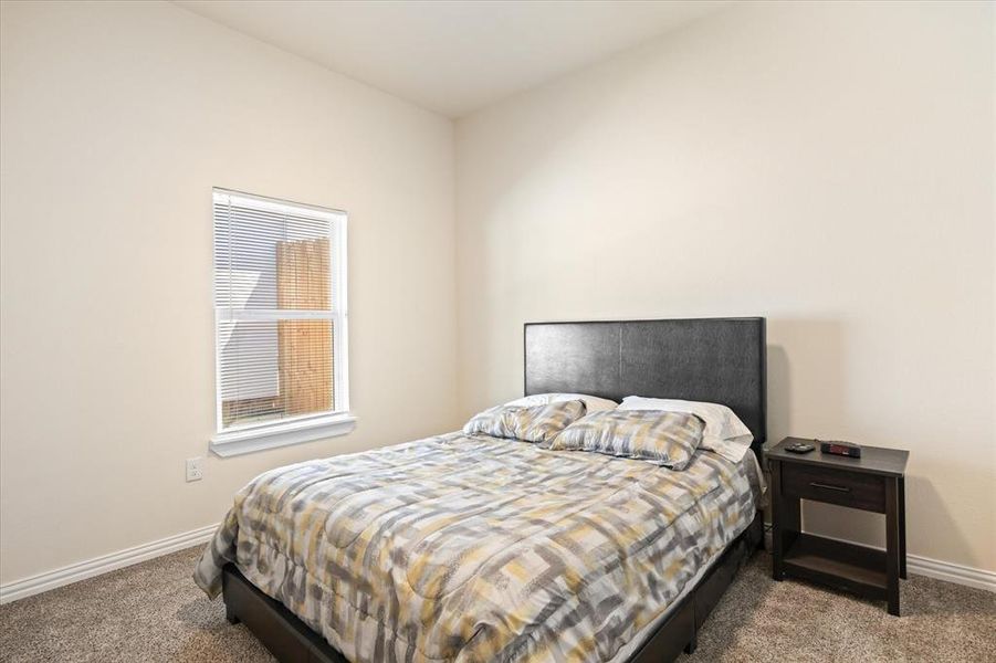 Bedroom with light colored carpet