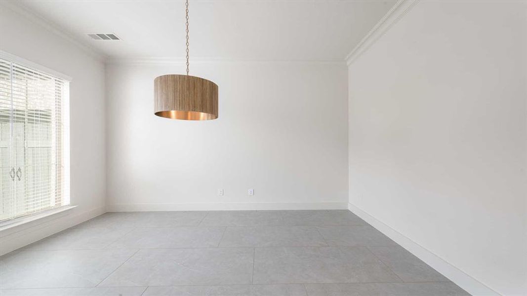 Tiled empty room with crown molding