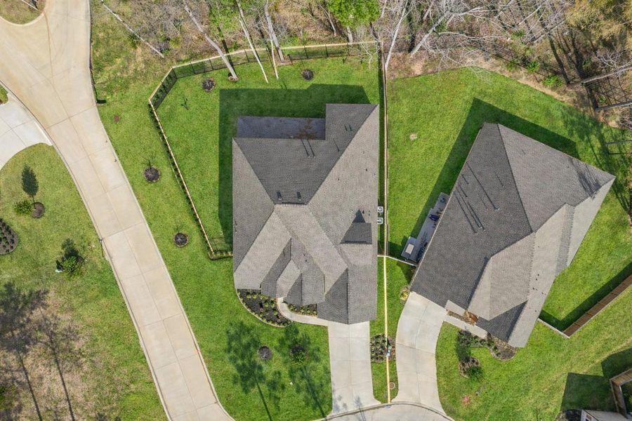 This aerial photo highlights how the home is nestled on a cul-de-sac lot backing up to the woods.