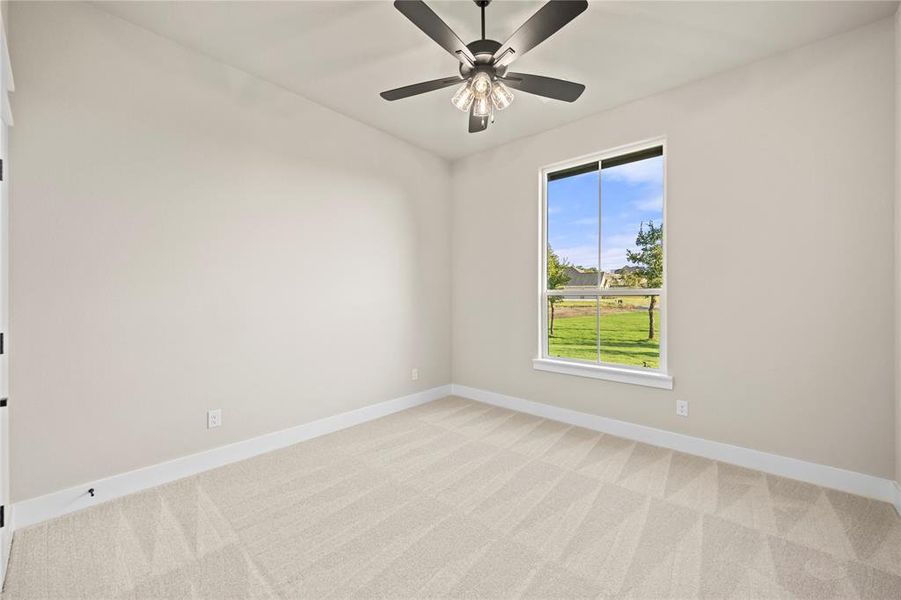 Empty room with light carpet and ceiling fan