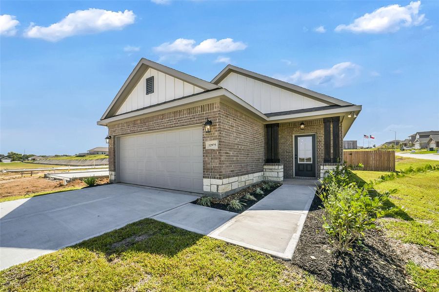 Front exterior of a new home in Mostyn Springs, Magnolia, TX, highlighting curb appeal (Image 1).