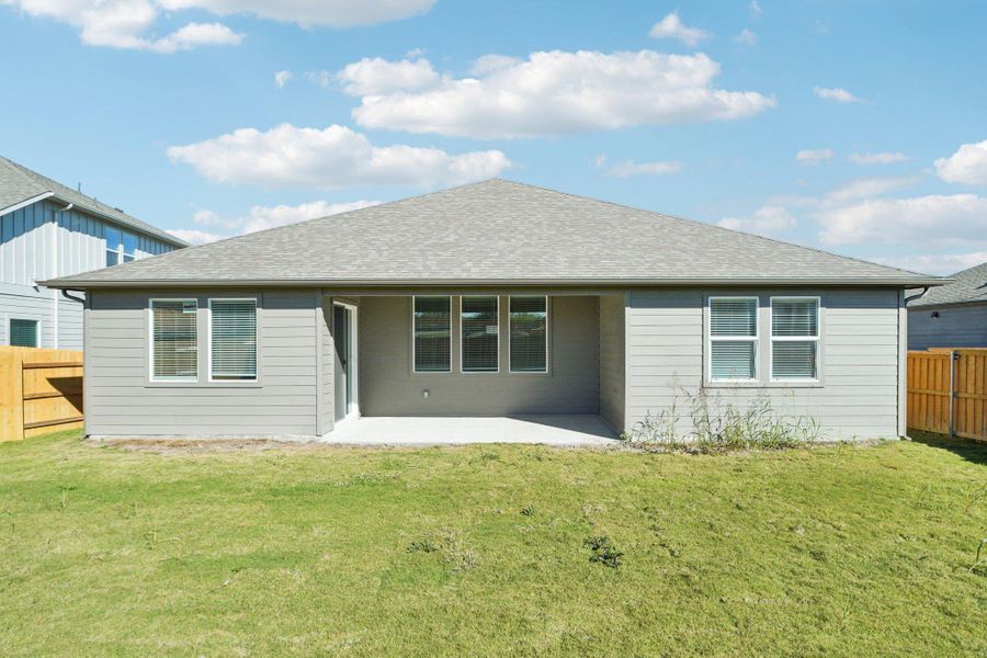 Back of house with a patio area and a shingled roof Back of house with a patio area and a shingled roof