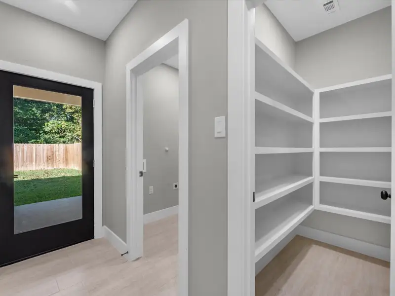 Hallway towards backyard, laundry room, walk in pantry Hallway towards backyard, laundry room, walk in pantry