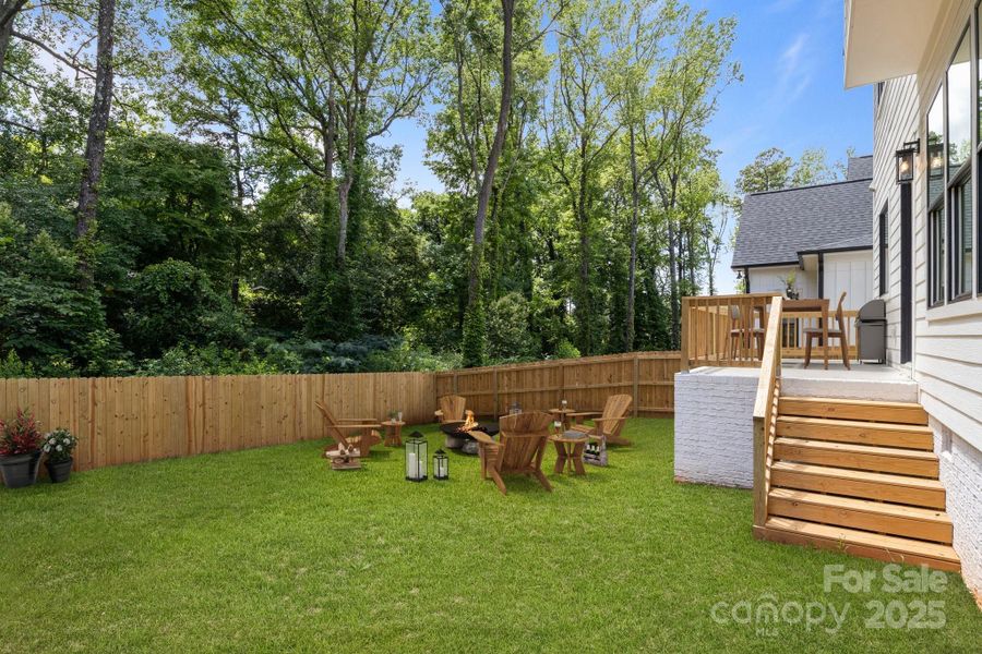 Virtually enhanced to show potential with greener lawn and fire pit