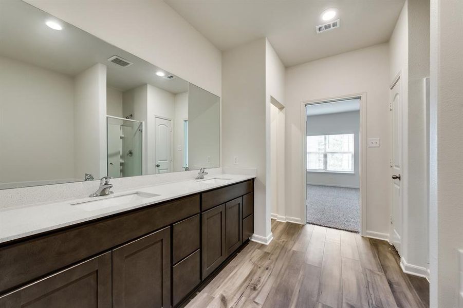 Bathroom featuring dual vanity and wood-type flooring