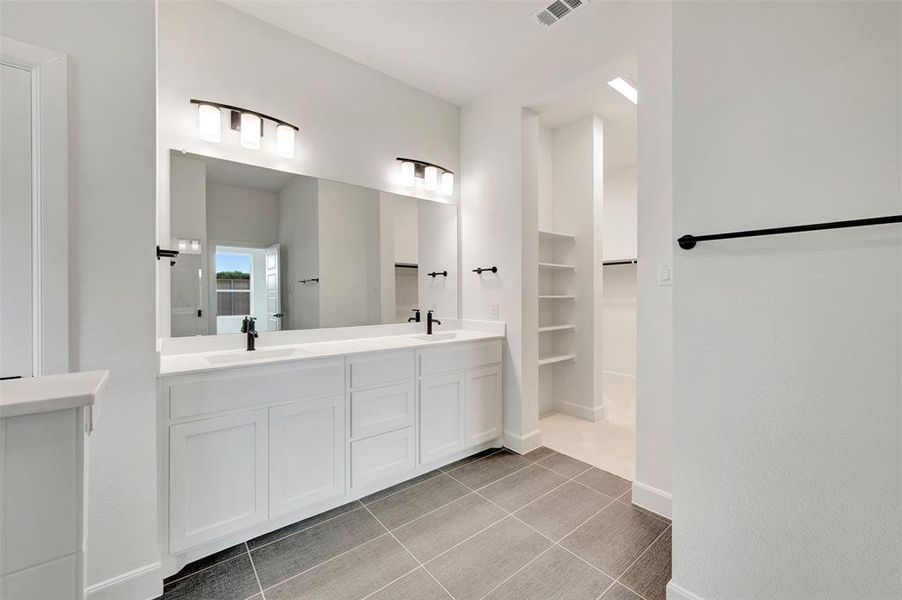 Dual sink vanity featuring white cabinetry and quartz countertops