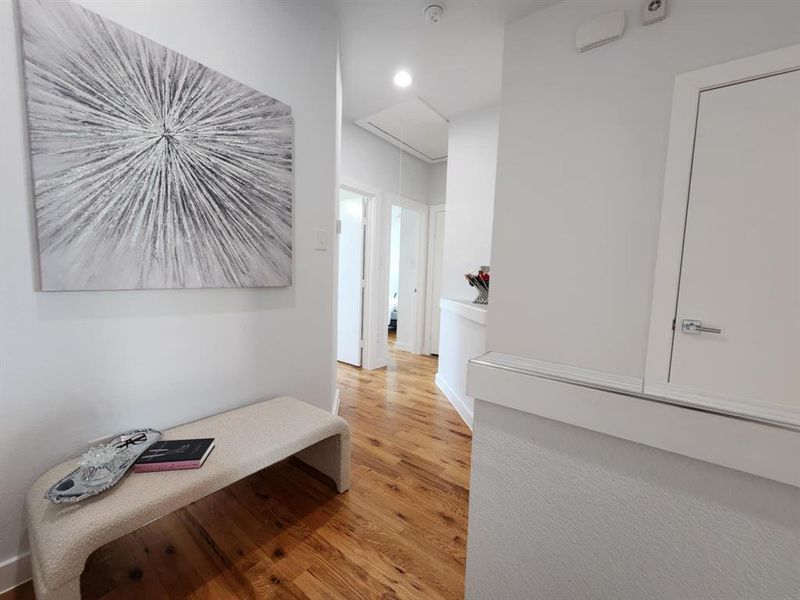 Hallway with light hardwood / wood-style flooring