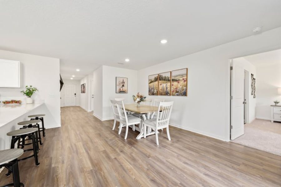 A dining room with a wood floor.