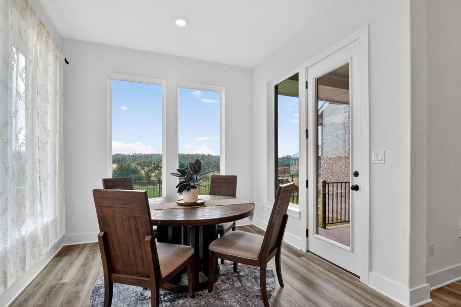 Dining area featuring wood-finish flooring and white baseboards Dining area featuring wood-finish flooring and white baseboards