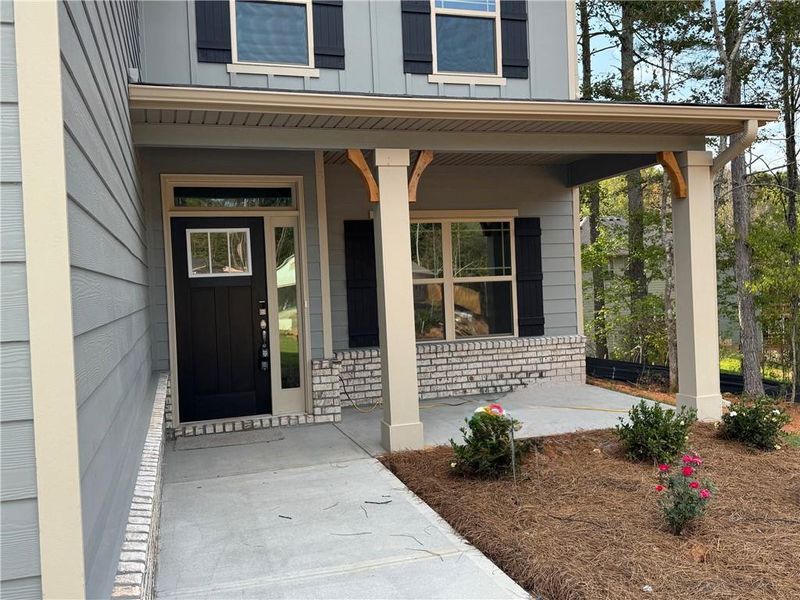 Front exterior of a new home in Magnolia Villas, Cornelia, GA, highlighting curb appeal (Image 1).