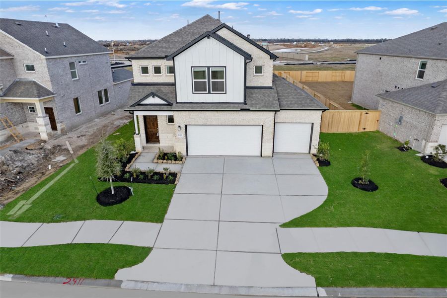 Front exterior of a new home in Creekhaven, Iowa Colony, TX, highlighting curb appeal (Image 21).