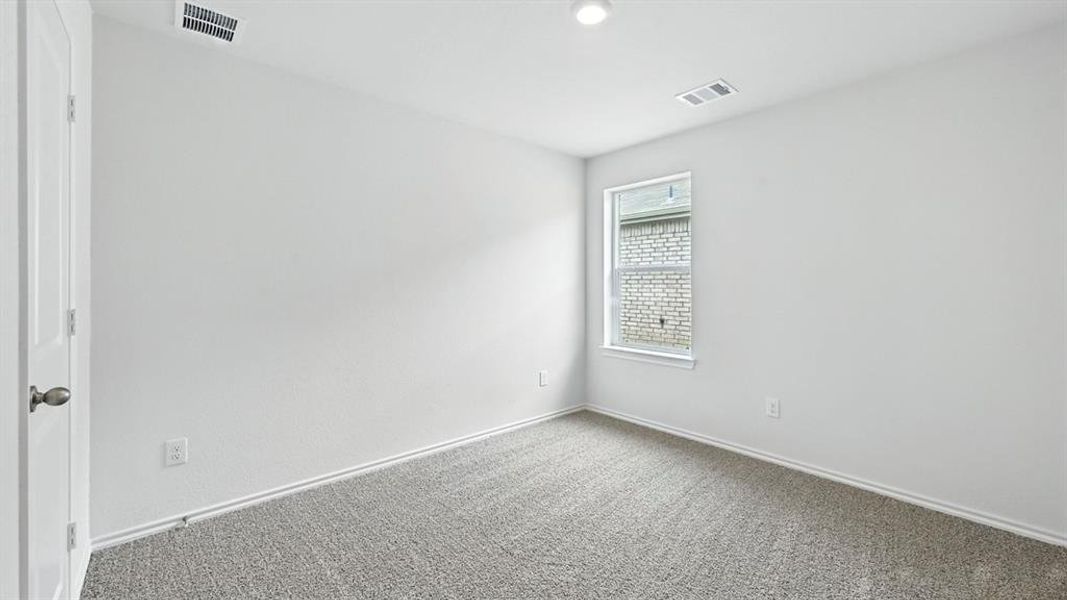 Neutral wall paint, gray carpet flooring, white trim, single window, and a recessed ceiling light Neutral wall paint, gray carpet flooring, white trim, single window, and a recessed ceiling light