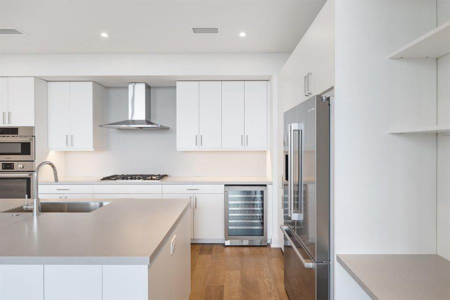 Kitchen is completed with built-in home office area with Silestone Quartz desk and shelving.