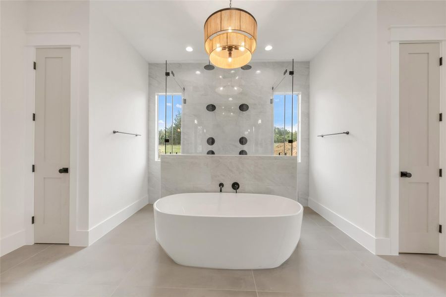 Bathroom featuring recessed lighting, a stall shower, light tile patterned flooring, and a soaking tub