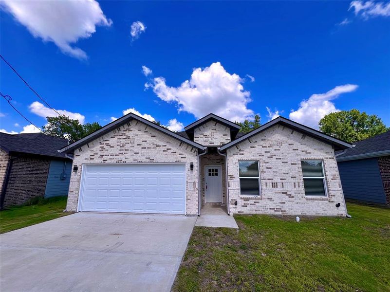 Ranch-style home featuring driveway, a front lawn, an attached garage, and brick siding Ranch-style home featuring driveway, a front lawn, an attached garage, and brick siding