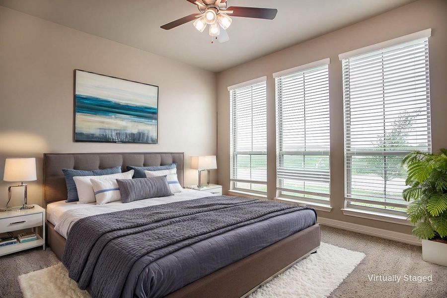 Bedroom featuring baseboards, a ceiling fan, carpet, and multiple windows