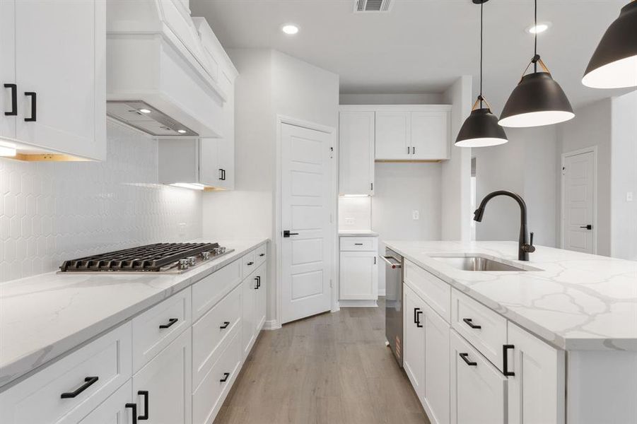 A clean crisp white color palette, designer backsplash and lovely flooring effortlessly pair with contemporary stainless steel and black accents to create a kitchen for the ages! A clean crisp white color palette, designer backsplash and lovely flooring effortlessly pair with contemporary stainless steel and black accents to create a kitchen for the ages!