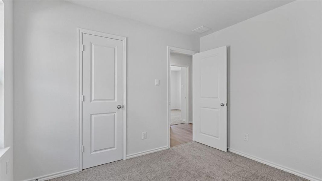 Interior room featuring neutral gray carpeting and white walls