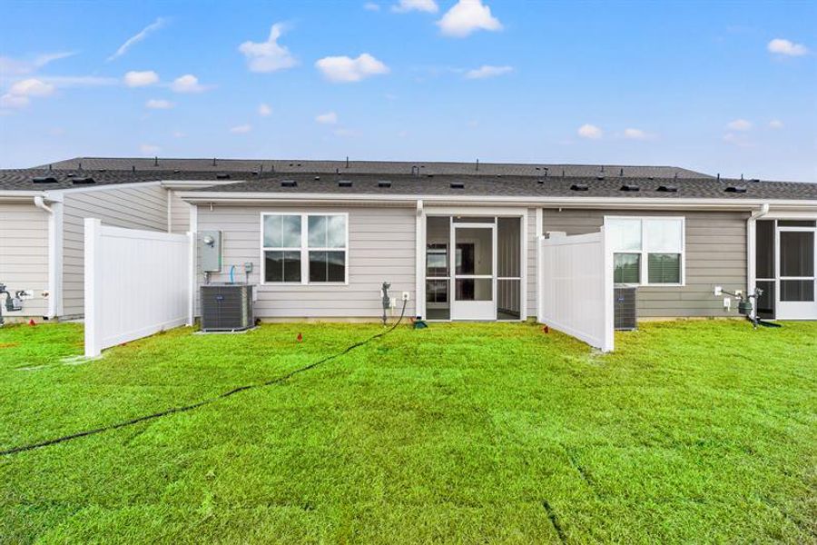 Exterior details and patio area of a home in Lakes at Riverbend, Navassa (Image 2).