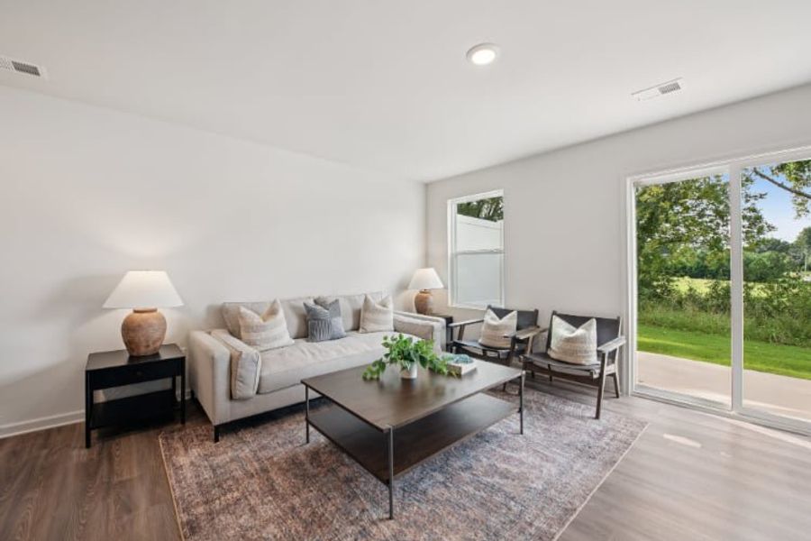 A living room with a large glass door.