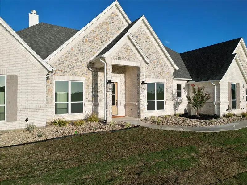 Front exterior of a new home in , Azle, TX, highlighting curb appeal (Image 1).