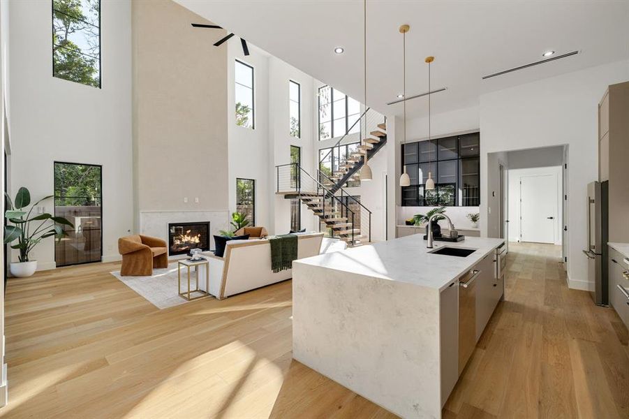 Expansive open-concept interior featuring light wood-finish flooring