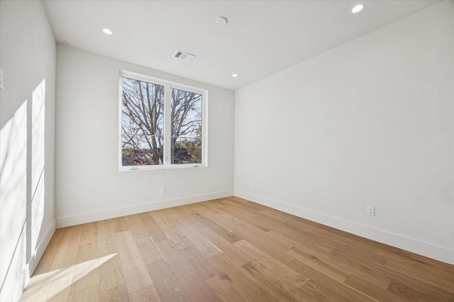Third secondary bedroom with recessed lighting and a walk-in closet with built-ins.
