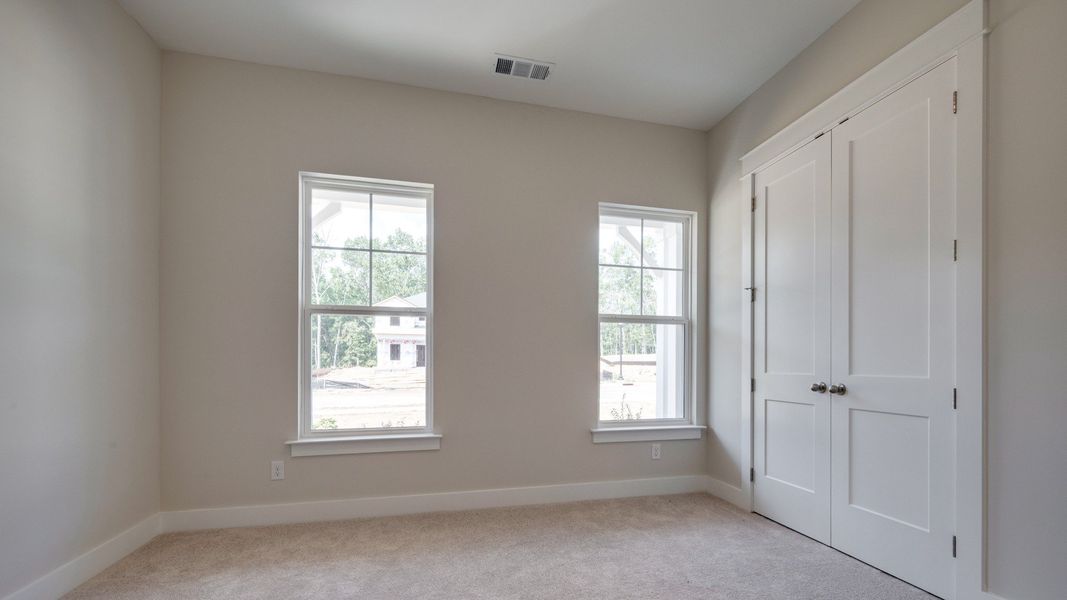 Secondary bedroom with double door closet next to front door