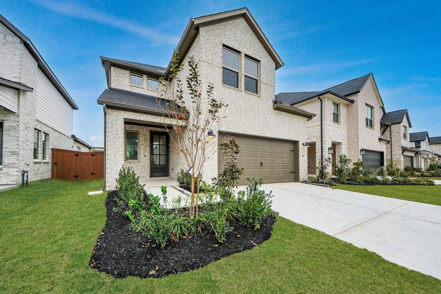 Front exterior of a new home in Elyson, Katy, TX, highlighting curb appeal (Image 24).