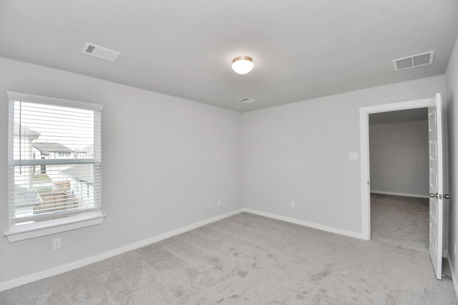 Generously sized secondary bedrooms featuring spacious closets, soft and inviting carpeting underfoot, large windows allowing plenty of natural light, and the added touch of privacy blinds for your personal retreat.
