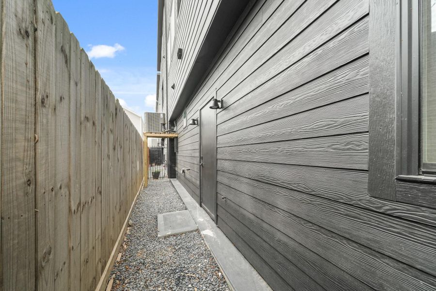 The low maintenance backyard features a clean aesthetic with black gravel and is fully equipped for outdoor living with a water spigot and a gas stub for easy grill hookups. The low maintenance backyard features a clean aesthetic with black gravel and is fully equipped for outdoor living with a water spigot and a gas stub for easy grill hookups.