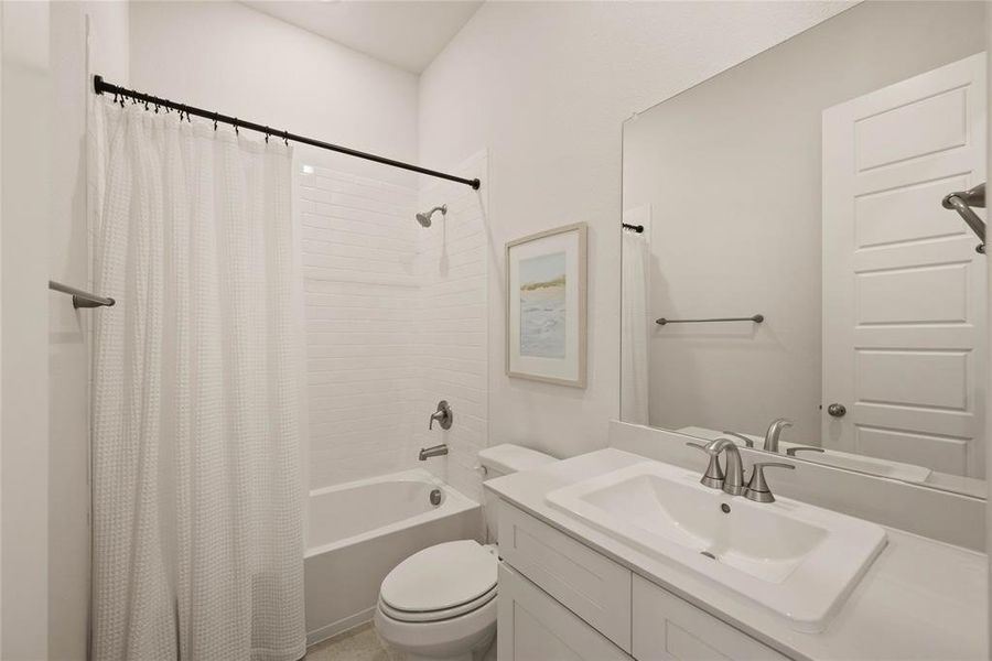 Full bathroom featuring vanity, toilet, and shower / bath combo with shower curtain