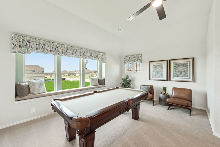 Game room with pool table, carpet flooring, window seat, and ceiling fan