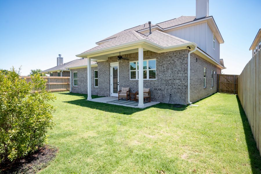 Front exterior of a new home in Greens Prairie Reserve, College Station, TX, highlighting curb appeal (Image 24).