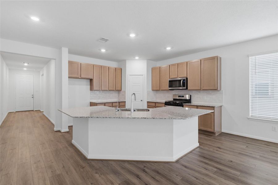 The extended breakfast bar provides additional seating—perfect for a quick meal—while keeping you connected to conversations in both the kitchen and Great Room.