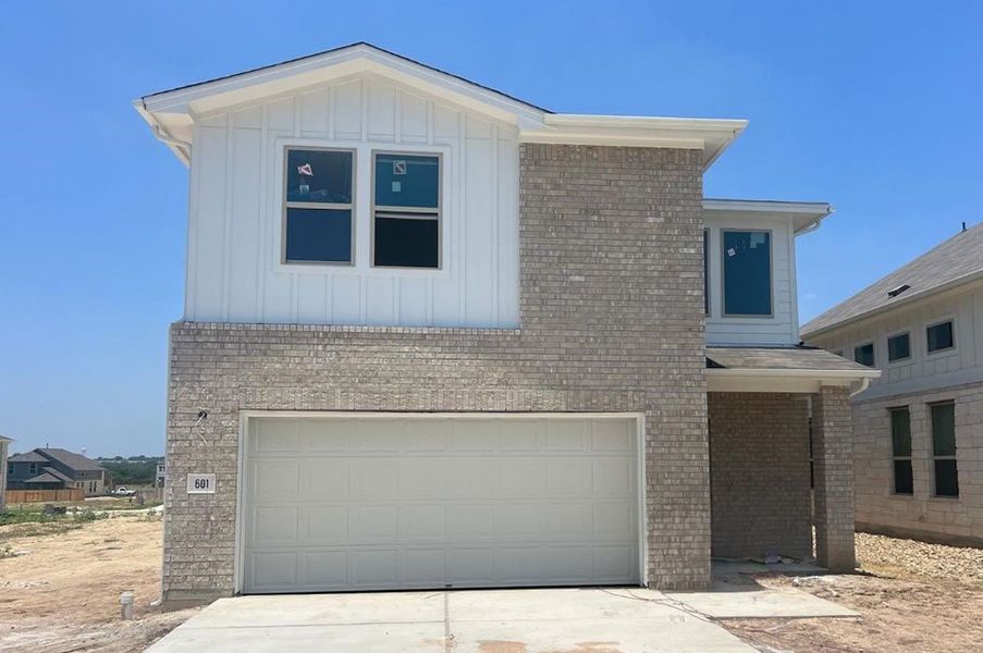 Front exterior of a new home in Crosswinds, Kyle, TX, highlighting curb appeal (Image 7).