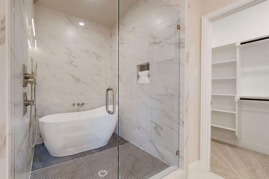 Main Bathroom with tile walls and independent shower and bath