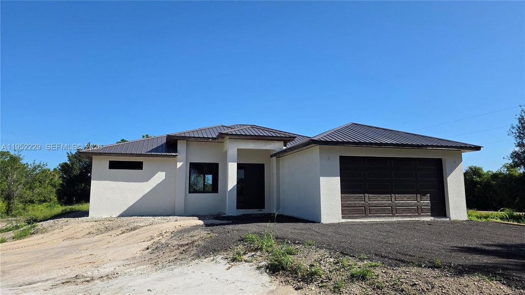 Front exterior of a new home in , Clewiston, FL, highlighting curb appeal (Image 7).