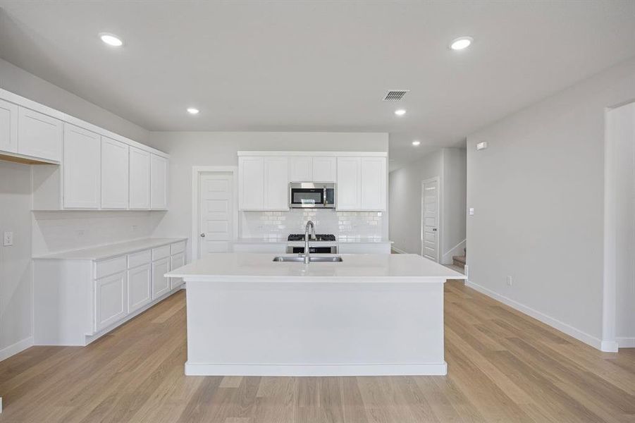 Kitchen in the Masters home plan by Trophy Signature Homes – REPRESENTATIVE PHOTO